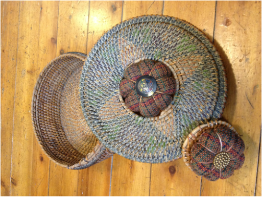 antique basket with handwoven pincushions